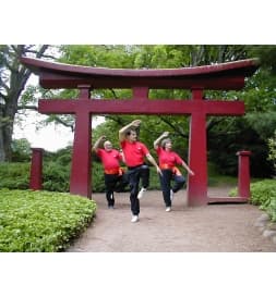 Gentle Do Tai Chi students practicing outside beneath a red gate