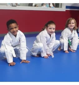 Young martial arts students smiling together